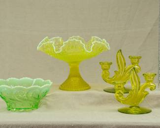 More uranium glass pieces including a pair of Duncan and Miller’s Canterbury (#115) pattern uranium glass candlesticks 