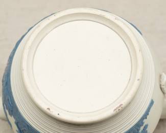 Closeup of the antique circa 1810 Chetham and Woolley Hunt Jug, feldspathic stoneware cream color body with applied blue relief of a fox hunting scene, smear glazed. Chetham & Woolley was an earthenware manufactory in Staffordshire, England established by James Chetham & Richard Woolley around 1795.