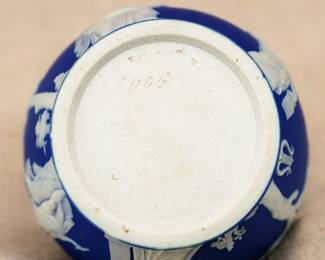 Closeup of the small, Wedgwood, blue dip jasperware vase, decorated with in white relief with classical figures