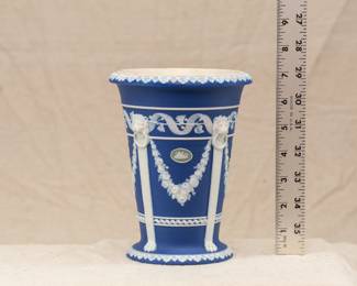A stunning and rare antique Wedgewood tri-color blue jasper dip with sage green cameo "Monopodia" vase, early 1900s.  Featuring architectural elements, not pictorial reliefs, the monopodia are used here as columns topped by a lion mask and terminated at the bottom by a single paw foot. A small oval sage green and white cameo adorns the side above a swag element and below a masterfully applied ribbon and vine border; acanthus leaves decorate the rim and the base.