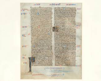 A closer look at a framed leaf from a Bible produced in the manner of William de Brailles workshop, Oxford, circa 1230-1240. Timothy leaf with fine gold initials and herringbone feathers emerging from the mouth of dragons.