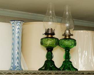 A tall signed Durand art glass pulled feather pattern vase, and a pair of hard to find antique emerald green glass kerosene lamps in the bullseye loop pattern.