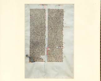Closer view of the framed page from The Biblia Sacra Latina, a Latin Bible produced by the “Alexander atelier” in Paris, between 1220-1230. The page from the Latin Bible (21.2 x 14.5 cm) written in brown ink in a neat, highly compressed quadratus Gothic bookhand in 49 double-columned lines per side on thin, smooth, cream-colored vellum. Book of Ezra aka Nehemiah. Recto: page heading “DRE” Verso: page heading “ES”