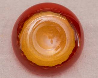 Closeup of the antique hand blown Amberina glass finger bowl or rose bowl