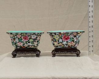 Pair of vintage Chinese porcelain famille rose mille fleur planters with carved wooden stands