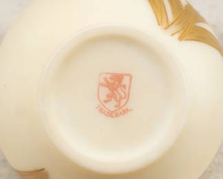 Closeup of the base of Smith Brothers antique cream color satin glass vase with hand-painted gilt iris flower, marked on the base with Smith Brothers stamp; late 19th century (1874-1899.)