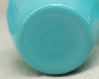 Closeup of the opaque blue glass water carafe with glass.