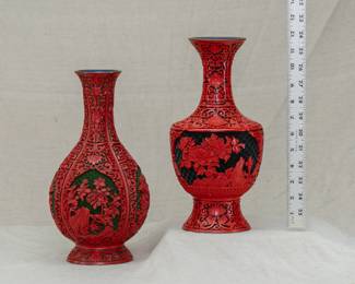 Two vintage Chinese large cinnabar lacquer vases, beautifully carved with floral motif and scrolling design on a black geometric ground, original maker's label to underside of one of the vases.