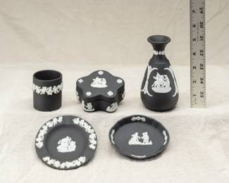 A group of five Wedgwood black jasper ware pieces including a vase and a lidded trinket box