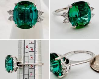An incredible four carat tourmaline ring, the large central stone flanked by two pair of diamonds set in 14-karat white gold.  This is an incredible tourmaline with excellent color and saturation!