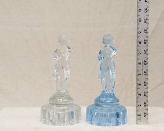A pair of smaller vintage flower frogs in clear and blue glass