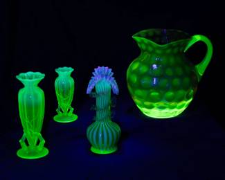 Seen under black light: More uranium glass items including a water pitcher, a pair of two different size "Tiny Twigs" pattern opalescent vaseline glass bud vases, made by Northwood around 1898 and around 1908 by Dugan from the same molds