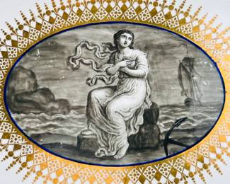 Closeup of the stand or underplate from the Worcester Porcelain (Flight) lidded sauce tureen with stand from the ‘Hope service’ circa 1792, signed with blue crowned script Flight and open crescent marks, painted by John Pennington. The celebrated 'Hope' service was commissioned by the Duke of Clarence and St Andrews (later King William IV), in January 1790, and was completed just over a year later. The stand shows one of the three different scenes of the Greek mythological Hope, painted in monochrome using the French-inspired grisaille style, that adorn this lidded tureen and stand.