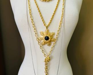 Beautiful costume jewelry necklaces in various lengths including a gold star and black stone pendant on a gold link chain (Erwin Pearl), a long gold chain knotted in lariat style (Marshall Field), and two different length round-cut rhinestone chain necklaces (Les Bernard)