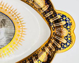 Closeup of the Worcester Porcelain (Flight) lidded sauce tureen with stand from the ‘Hope service’ circa 1792 showing the bold blue underglaze lobed border, beautifully painted with gilt patterae, and gilt arched panels and stars.