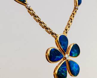 Closer view of the 14k yellow gold and black opal with diamonds pendant necklace 