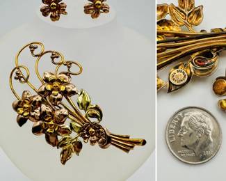 A graceful flower form sterling silver and gold filled demi parure, brooch and earrings set