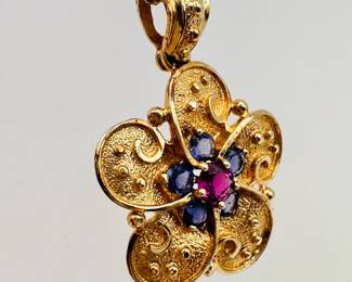 A closer look at the 14k yellow gold flower form pendant necklace, with faceted gemstones and 14k yellow gold chain
