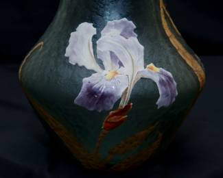 Closeup of the large Legras Mont Joye art glass vase, beautiful art nouveau design of blooming purple and white irises with gilt leaves against a textured frosted green glass ground, the rim with organic forms and scrolls of gilt. Mont Joye L C mark to the base.