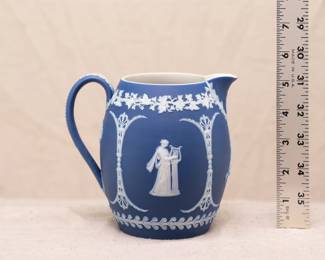 A small, Wedgwood, blue jasper dip pitcher decorated with classical figures and ornamentation