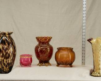 A variety of hand blown art glass vases and rose bowls