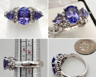 A beautiful ring with an approximate 1.35 carat tanzanite flanked by diamonds and a pair of tanzanites set in 14-karat white gold.