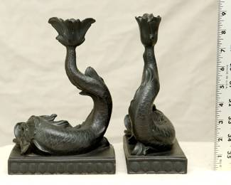 Pair of Wedgwood black basalt dolphin candlestick holders, in the form of a dolphin resting on a rectangular plinth decorated with scallop shells; impressed "Wedgwood" signature to the underside