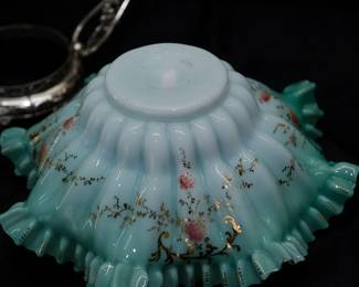 Closeup of 19th century ruffled art glass bowl bride's basket with silver plated basket handle stand