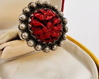 Closeup of the charming sterling silver and carved cinnabar ring