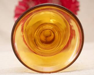 Closeup of the base of the beautiful 13-1/2 inch hand blown Amberina glass vase with double crimped flaring rim and disc foot