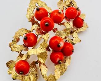Closeup of 14k yellow gold and coral bead brooch