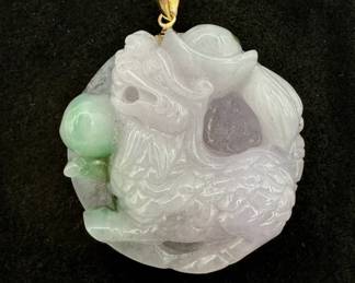 A Chinese carved jade pendant of a Pixiu (also known as bixie or tian lu), a mythical, auspicious creature that symbolizes wealth and protection