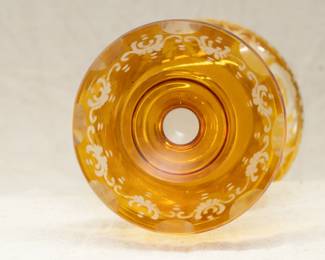 Closeup of the finely made Bohemian art glass vase in amber cut to clear.