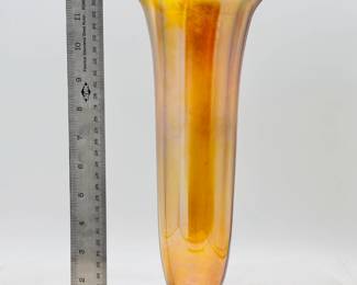 A signed Louis Comfort Tiffany favrile art glass flower vase, gold iridescent favrile glass, footed, ribbed cylindrical form with cupped mouth and wavy rim, signed in etch on base '1549' and "L. C. Tiffany - Favrile' for Tiffany Studios, first quarter 20th century; 13-1/2 inches high