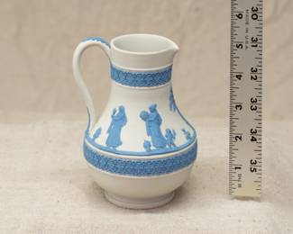 A vintage Wedgwood reverse colors jasper "Etruscan" style jug, cream color body with blue applied Grecian mythological figures in the "sacrifice to Cerus" motif between two bands of blue arabesques. 20th century.