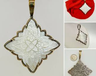 A signed Stephen Dweck sterling silver and hand carved mother of pearl pendant with original fabric pouch