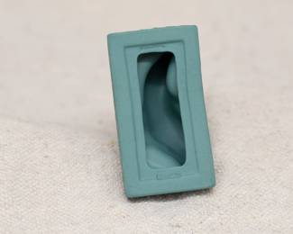 Closeup of the Wedgwood teal green jasperware miniature 3-inch-high dolphin candlestick holder