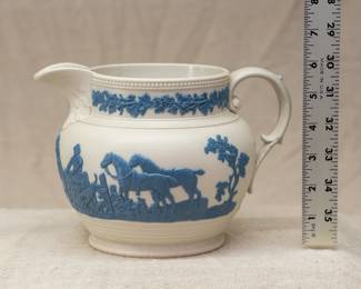Antique circa 1810 Chetham and Woolley Hunt Jug, feldspathic stoneware cream color body with applied blue relief of a fox hunting scene, smear glazed. Chetham & Woolley was an earthenware manufactory in Staffordshire, England established by James Chetham & Richard Woolley around 1795.