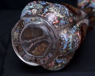Closeup of the stunning and large antique Bohemian art glass vase (Moser? Harrach?) intricately painted overall with acanthus leaf scrolls in polychrome enamel, with cranberry glass panels containing wheel carved gilded flowers, and gold gilding at the flared rim.