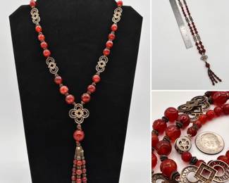 A sterling silver and carved carnelian bead necklace, with beaded tassel pendant