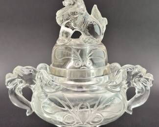 Another view of the Chinese carved rock crystal censer and cover, early 20th century, of compressed globular form, resting on three short paw-shaped feet, the lid surmounted with a seated mythical beast, shoulders are flanked by mythical beast mask handles. Both the lid and body are carved with taotie mask designs.