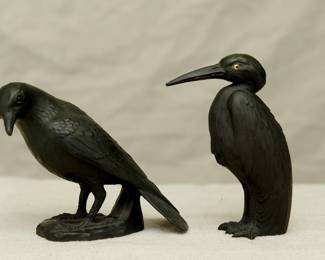 A Wedgwood black basalt model of a blackbird circa 1920 modeled by Ernest Light, with applied glass eyes, finely modeled details to the feathers, standing on a shaped base, and a Wedgewood black basalt model of a heron, also by Ernest Light