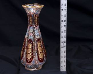 A stunning and large antique Bohemian art glass vase (Moser? Harrach?) intricately painted overall with acanthus leaf scrolls in polychrome enamel, with cranberry glass panels containing wheel carved gilded flowers, and gold gilding at the flared rim.