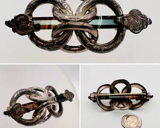 Scottish pebble jewelry: A exceptional antique Victorian Scottish silver and agate Love Knot brooch or cloak pin, showcasing a brown and black hexagon-cut agate, elegantly set in silver showcasing elaborately engraved interlocking rings.
