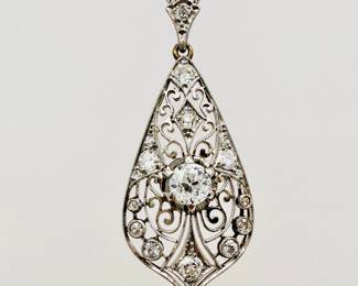 Closeup of the platinum and old European cut diamond pendant circa 1910 on a 14k gold white gold necklace chain