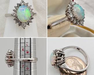 A classic ring featuring a beautiful opal with lovely fire in a raised basket setting encircled by diamonds set in 14-karat white gold.