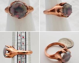 A lovely black opal ring in stylized modernist gold claw setting.