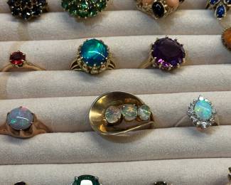 Close up showing some of the opal rings and a large tourmaline set in gold. 