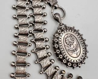Closeup of the beautiful antique 19th century book chain with locket pendant necklace, hallmarked English silver
