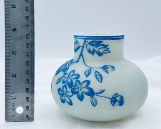 Antique Harrach or Thomas Webb & Sons cameo glass vase circa 1890, cased blue over creamy white, cameo cut around the body with flowering petals on leafy vines. A banded blue rim at the top and a polished pontil on the base.